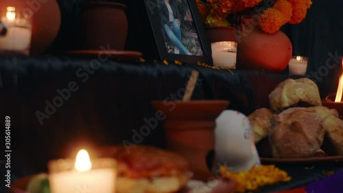 The photo of the deceased is placed on the altar together with the gifts during the Día de los muertos photo