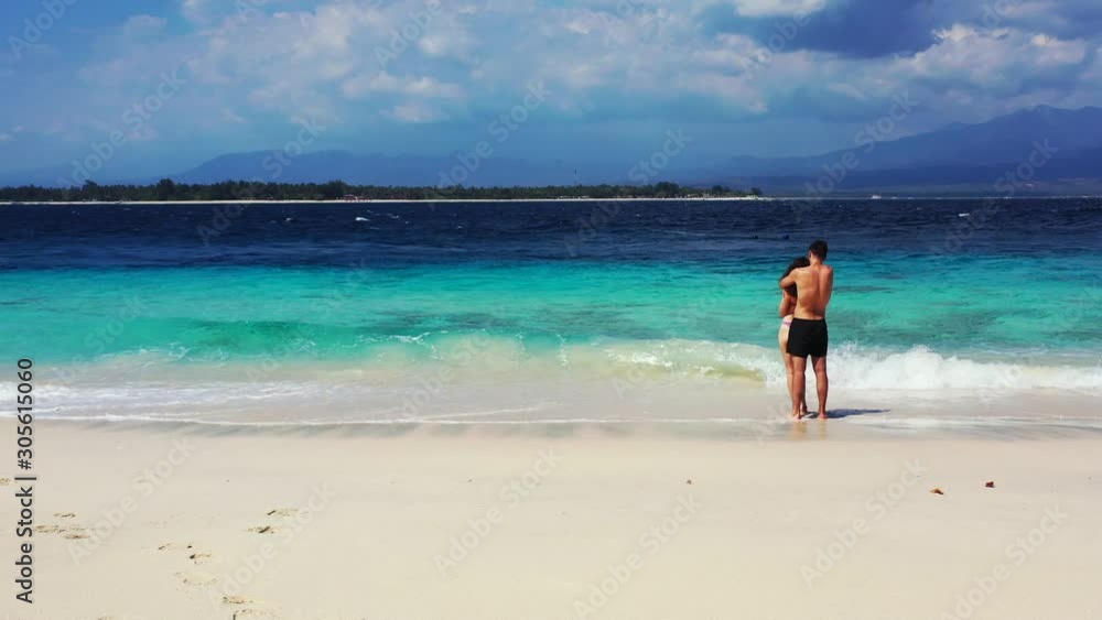 Romantic Couple Enjoying the Beautiful Scenery in Hawaii Under the Bright Blue Sky - Wide shot Romantic Couple Enjoying the Beautiful Scenery in Hawaii Under the Bright Blue Sky - Wide shot