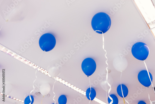 Blue and white color balloons in the room prepared for birthday party.