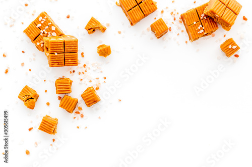 Tableau sur toile Salted caramel pieces - paradoxical sweets - on white background top view frame