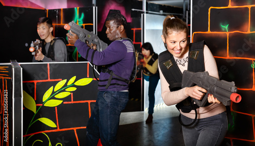 Young man and woman playing laser tag