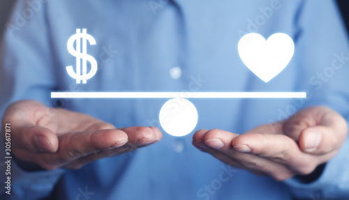 Man holding Money and Heart balance.