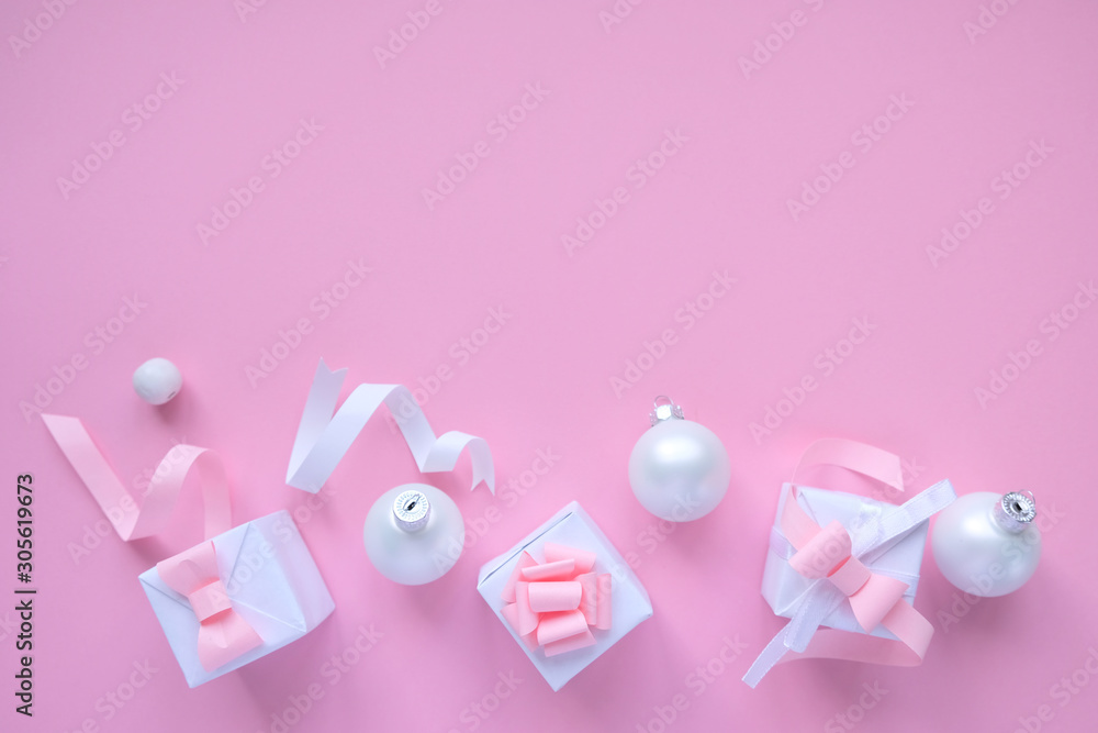 Christmas background with decorations and gift boxes on pink background Christmas background with decorations and gift boxes on pink background