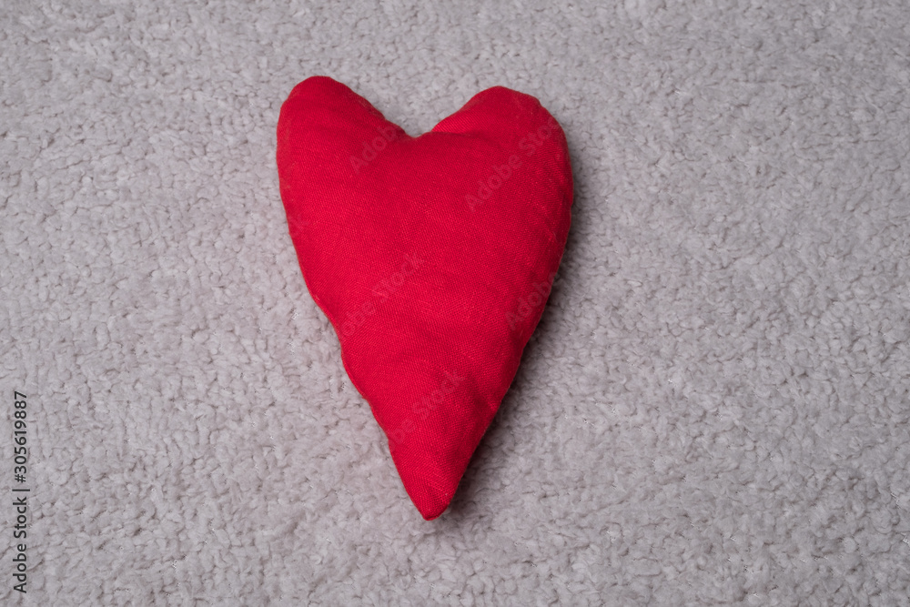 Fabric heart studio image. Red heart on a gray background.