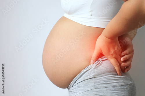 Pregnant women with low back pain on white background,Health concept