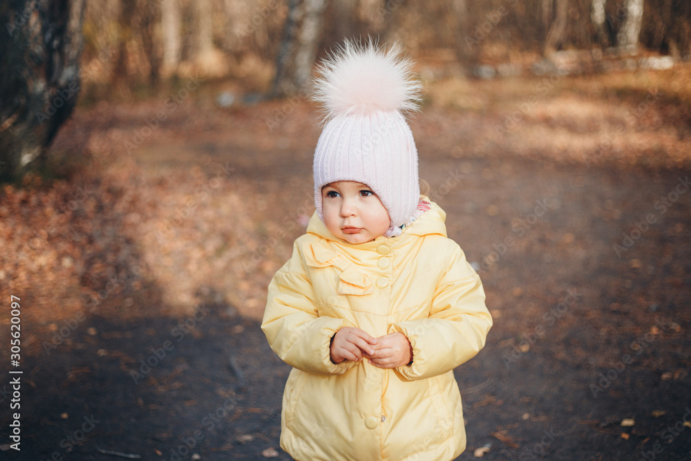 a little girl in a warm hat on his head smiled. the concept of childhood, health, IVF, cold time a little girl in a warm hat on his head smiled. the concept of childhood, health, IVF, cold time