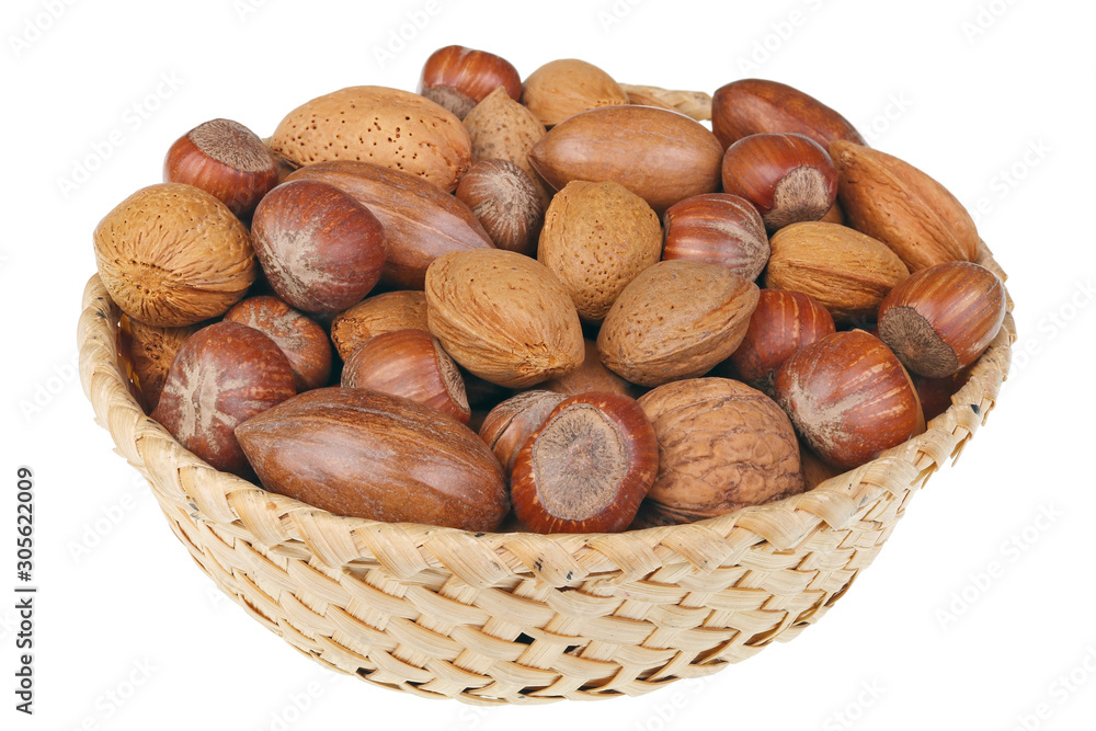 Wicker basket with hazelnuts walnuts almonds and cashew nuts for Christmas table isolated macro Wicker basket with hazelnuts walnuts almonds and cashew nuts for Christmas table isolated macro