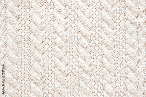 Cable knitting stitch pattern, soft woolen handmade knitted clothes texture.