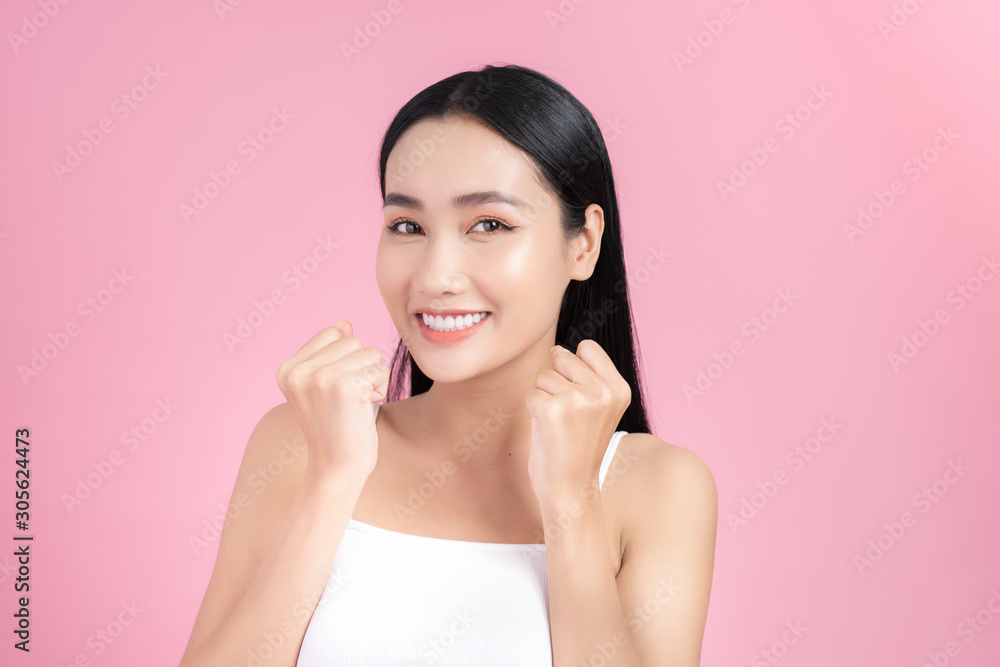 Excited beautiful young woman posing with perfect skin over pink background. Excited beautiful young woman posing with perfect skin over pink background.