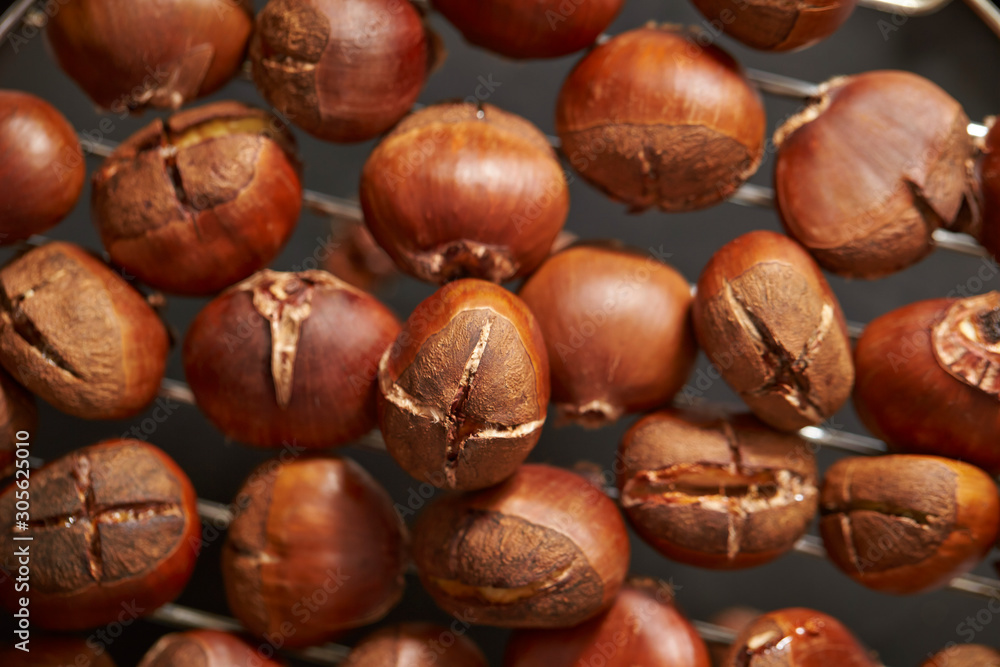 Roasted chestnuts on metal grill Roasted chestnuts on metal grill