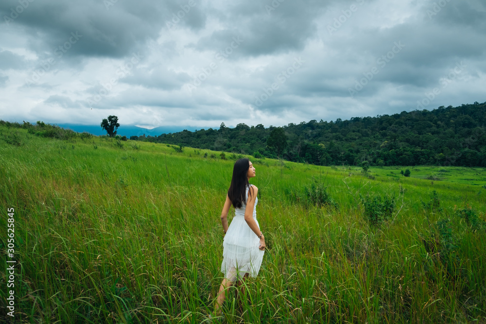 happy girl in a spring field, enjoying nature, beautiful woman in meadow,Freedom concept background. happy girl in a spring field, enjoying nature, beautiful woman in meadow,Freedom concept background.