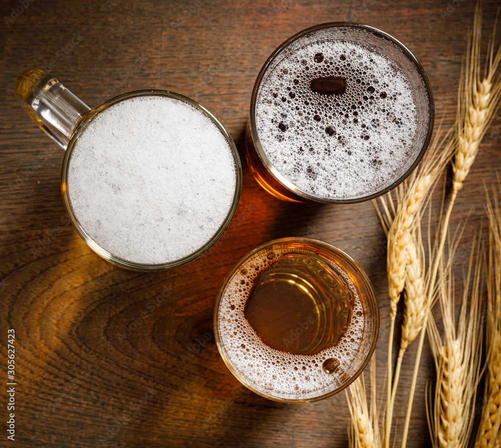 Three Glasses of Light Beer with wheat on the bar counter, copy space for your text Three Glasses of Light Beer with wheat on the bar counter, copy space for your text