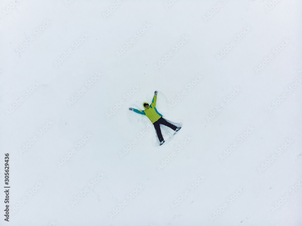 overhead view of man making snow angel