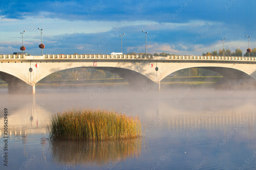 foggy beautiful morning in autumn near view of the bridge for transport