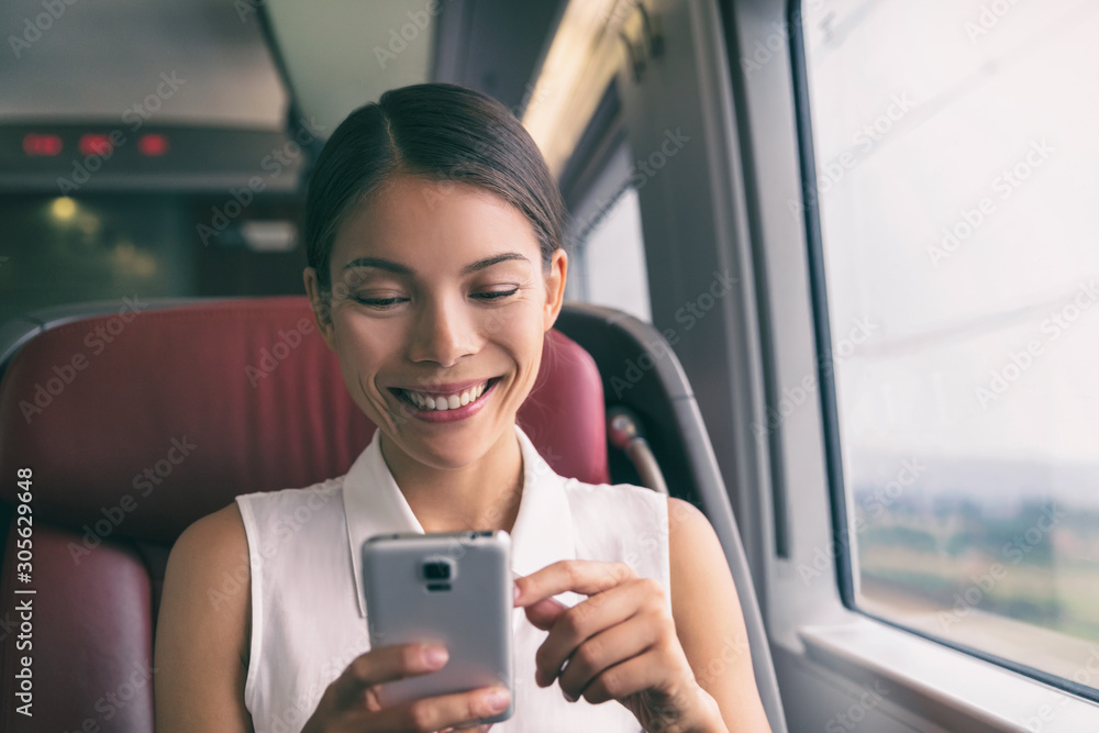 Train travel mobile phone Asian business woman using cellphone texting during commute to work. Commuting people lifestyle on transport with 5g device. Train travel mobile phone Asian business woman using cellphone texting during commute to work. Commuting people lifestyle on transport with 5g device.