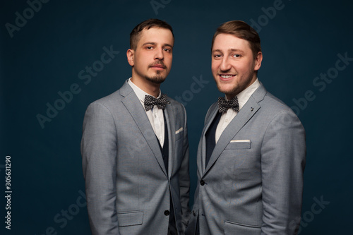 Two handsome positive men in formal clothes
