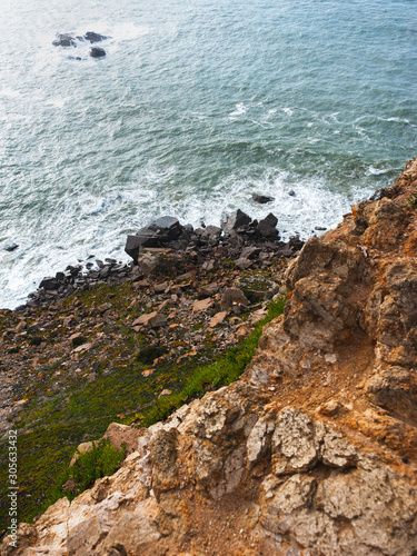 Waves breaking on the rocks, view from a cliff © maxpetrov