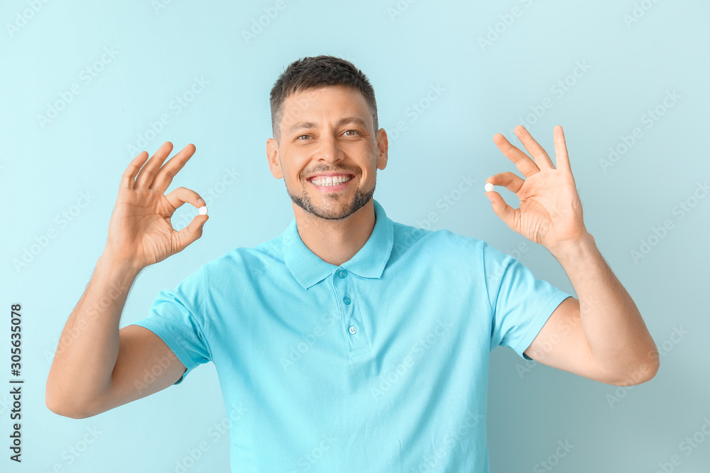 Man with pills on color background Man with pills on color background