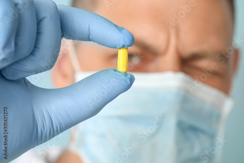 Doctor with pill, closeup view