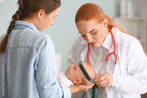 Woman with little baby visiting pediatrician in clinic