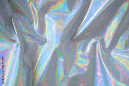 trendy holographic background.Silver metallic iridescent background.pastel colored  holographic texture in pink violet, Silver and  green colors.colorful chrome fabric.I