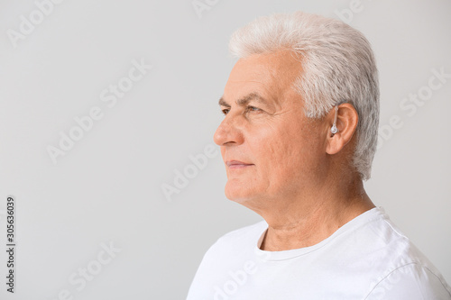 Mature man with hearing aid...