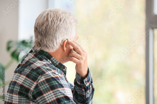 Mature man with hearing aid...