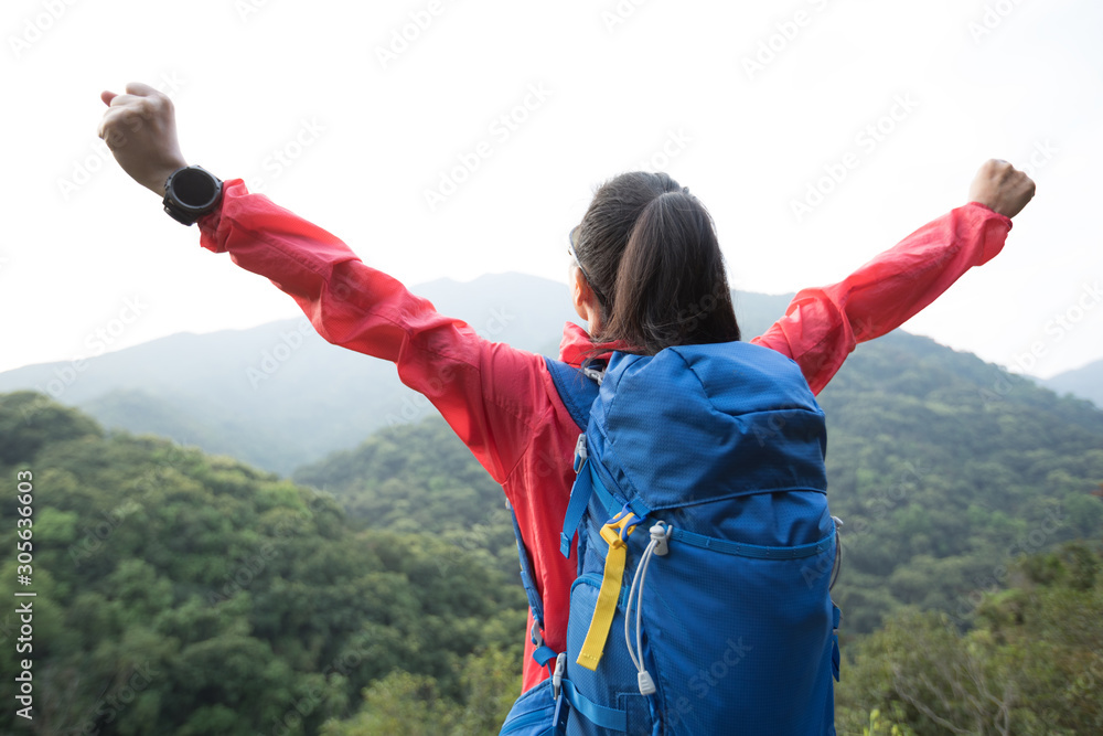 Cheering woman hiker enjoying the view on morning mountain valley Cheering woman hiker enjoying the view on morning mountain valley