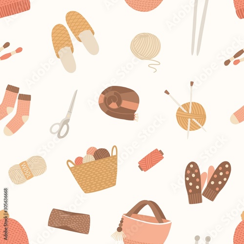 Knitted items vector seamless pattern. Skein of wool, knitting needles, yarn basket, woolen mittens, hand made scarf on white background. Cute and warm winter clothes and knitting tools backdrop.