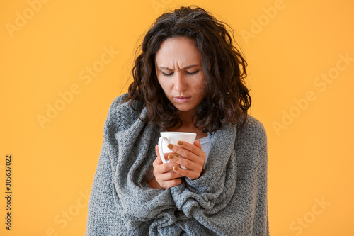 Woman ill with flu drinking...