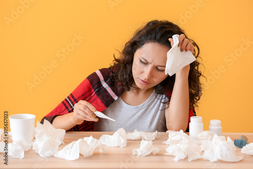 Sick woman measuring temper...