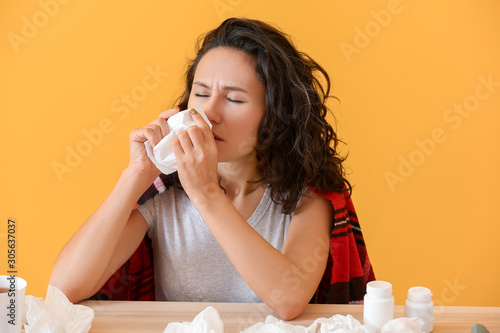 Woman ill with flu on color...