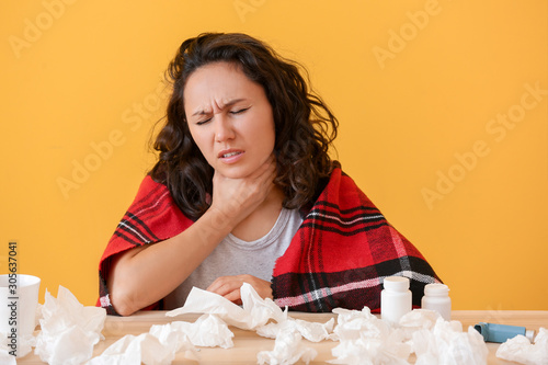 Woman ill with flu on color...