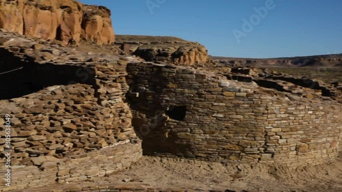 Quick pan from a brick lined hole in the ground that was used for cultural religious ceremonies thousands of years ago by the Anasazi people. This is a kiva at Chetro Ketl at Chaco Canyon, New Mexico.