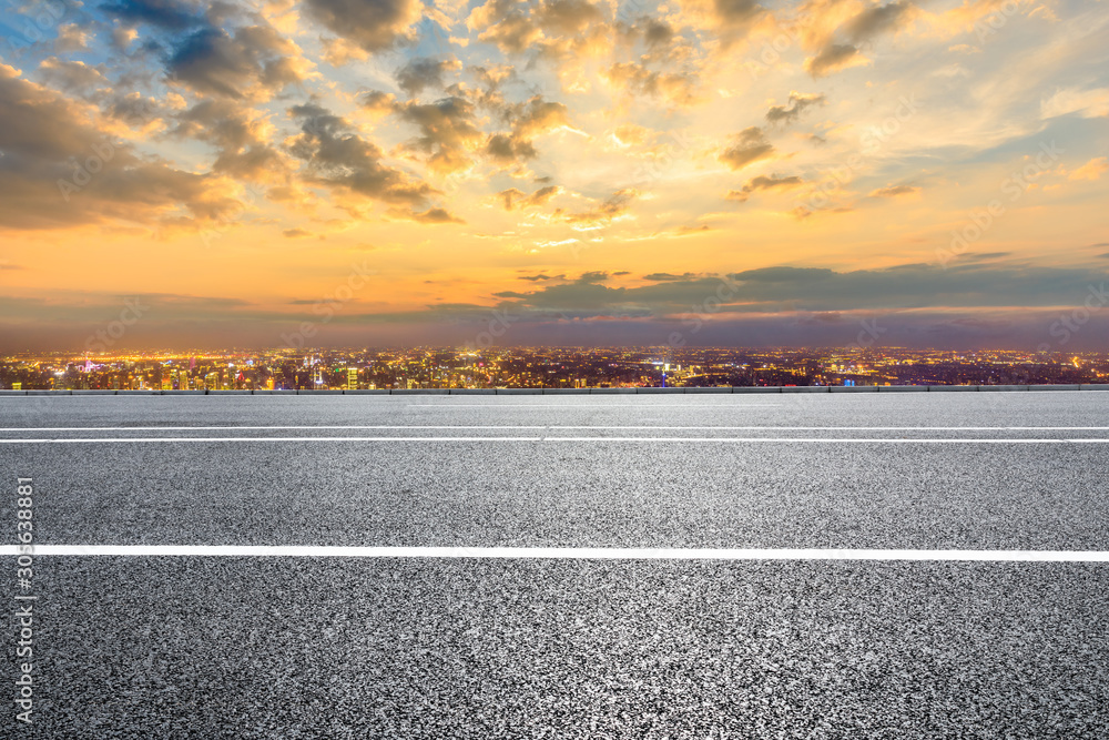 Fototapeta premium Shanghai city skyline and empty asphalt road scenery at sunset.