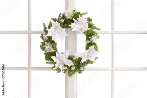 Beautiful Christmas wreath hanging on window photo