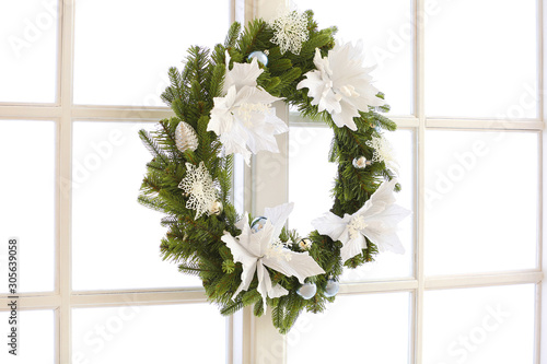 Beautiful Christmas wreath hanging on window photo