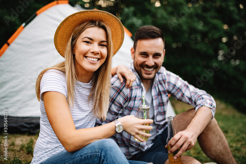 Young couple in tent camp on summer outdoor