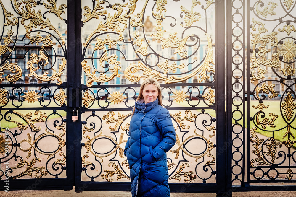 Tourist stands on the background of the gate to the Palace in Tsarskoye Selo