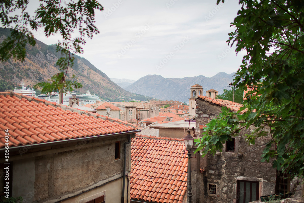 Tiled roofs in an old mediterranean town at summer day, Kotor, Montenegro, Europe