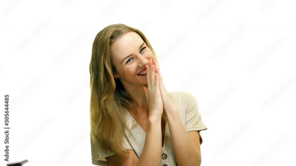 A beautiful young blonde woman laughing and grooving with joy isolated on white background. Slow motion.