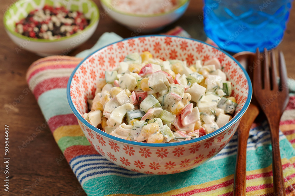 Bowl of Surimi Seafood Salad with sweet corn, cucumbers, boiled eggs and mayonnaise