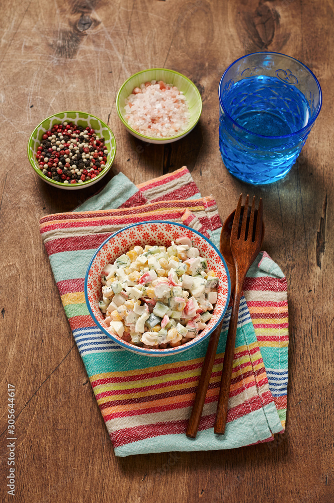 Bowl of Surimi Seafood Salad with sweet corn, cucumbers, boiled eggs and mayonnaise