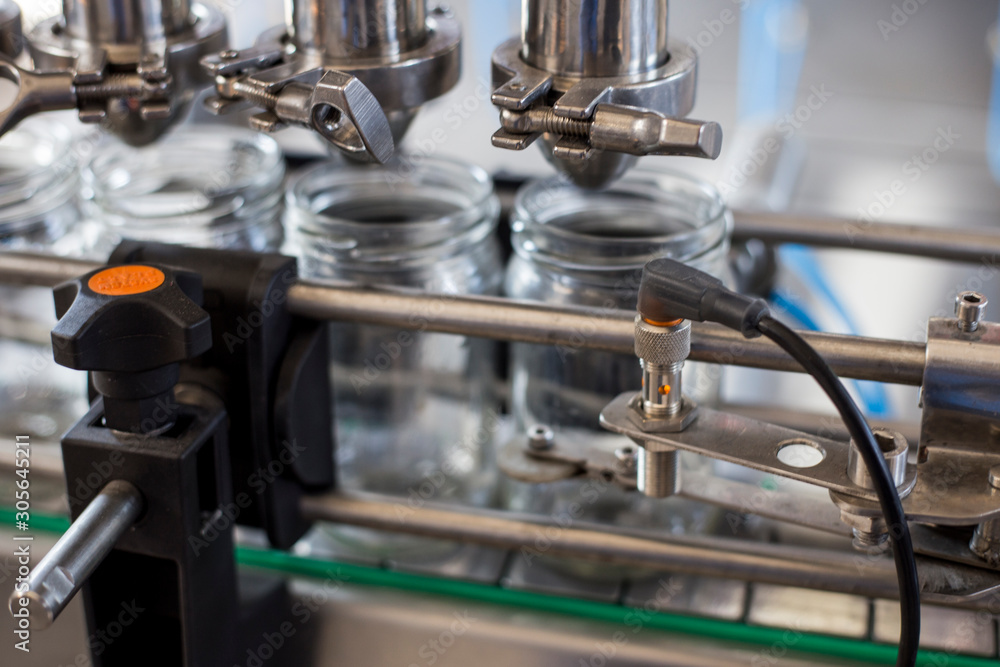 Glass jars on the conveyor Glass jars on the conveyor
