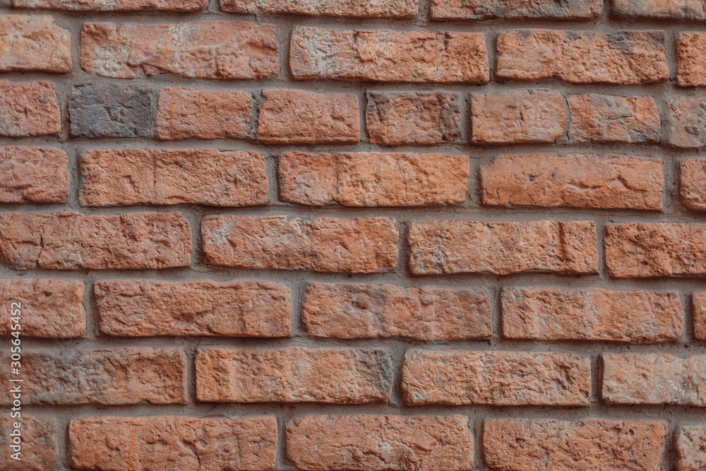 Obraz premium Red and gray brick wall with cement gaps. The old wall. Background, brick. Flat lay. Copy space, photo background.