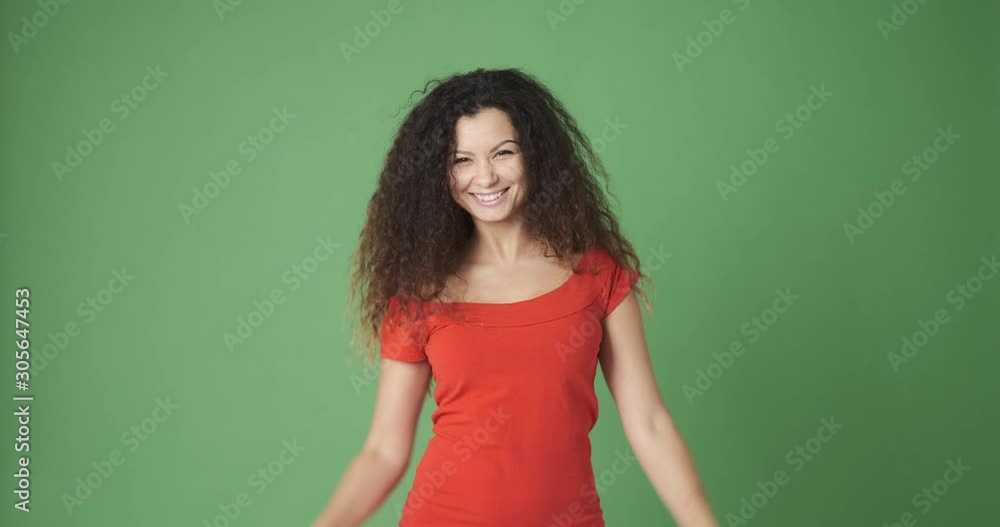 Excited woman searching with handmade binoculars waving goodbye and disappearing over green screen Excited woman searching with handmade binoculars waving goodbye and disappearing over green screen