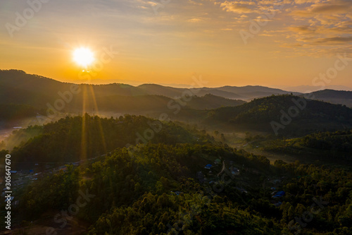 Aerial landscape with sunrise in the morning located in Maehongsan province, Thailand. © Panwasin