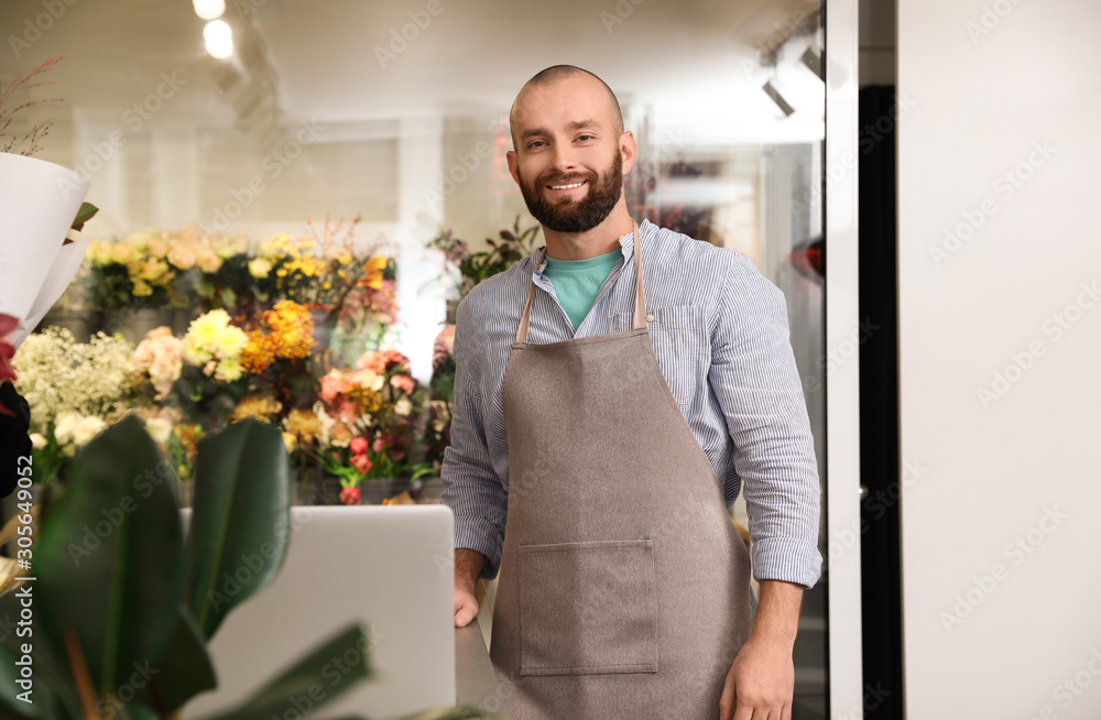 Professional male florist in apron at workplace Professional male florist in apron at workplace