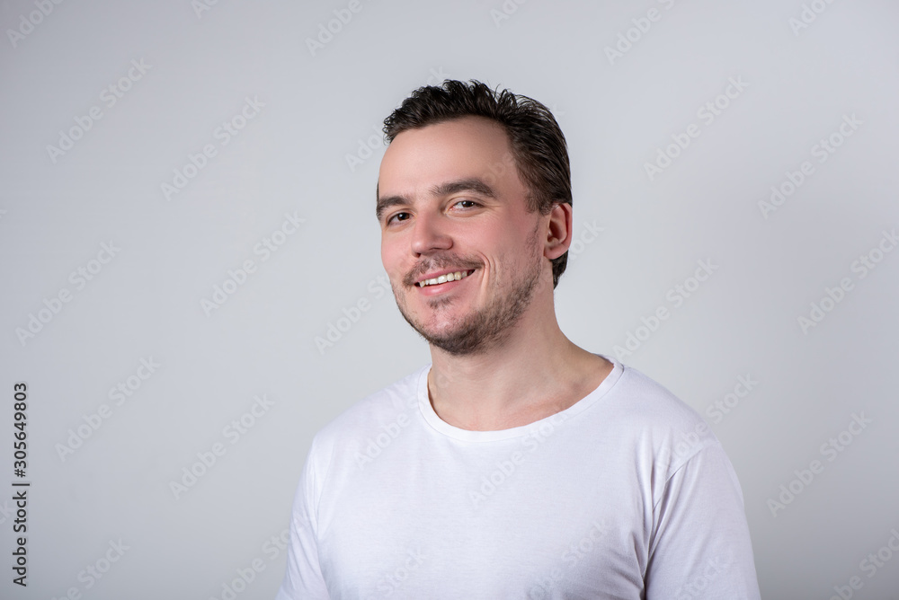 Handsome man with bristles in white t-shirt smiling Handsome man with bristles in white t-shirt smiling