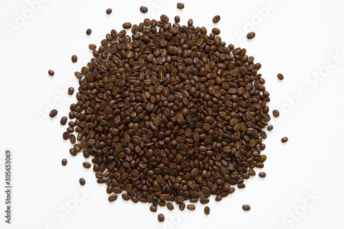 Circle of roasted coffee beans on white background, top view